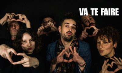 Le chanteur Lozange entouré de plusieurs personnes formant des cœurs avec les mains, dans une ambiance festive issue du clip "Va te faire".